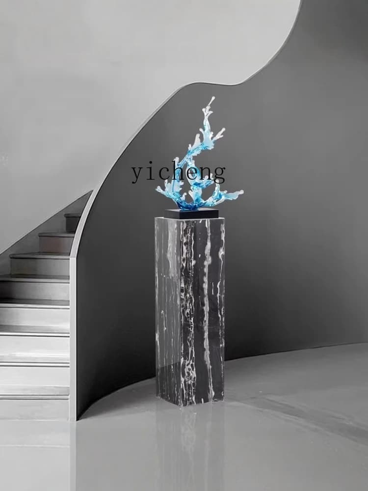 Elegant black and white veined marble pedestal stand in a modern interior setting.
