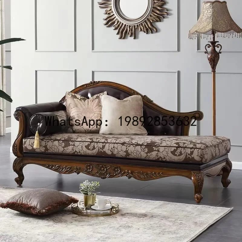 Ornate hand-carved solid wood chaise longue sofa with leather and floral fabric upholstery.