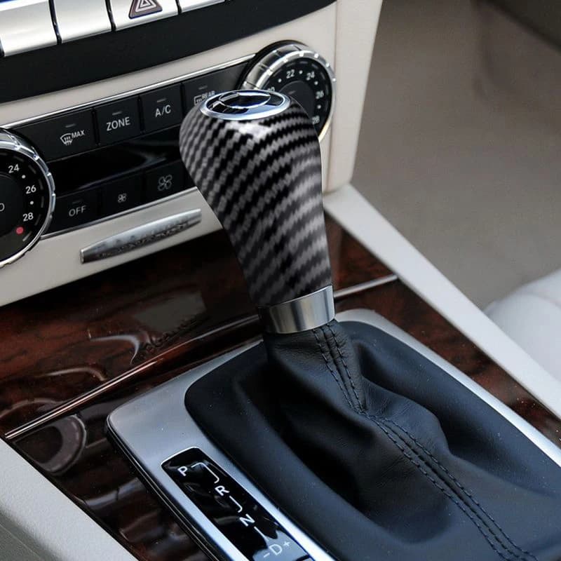 Carbon fiber style gear shift knob cover trim for Mercedes-Benz.