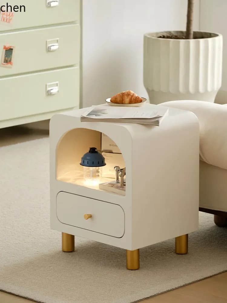 Minimalist white solid wood narrow bedside table with gold legs and an arched storage niche.
