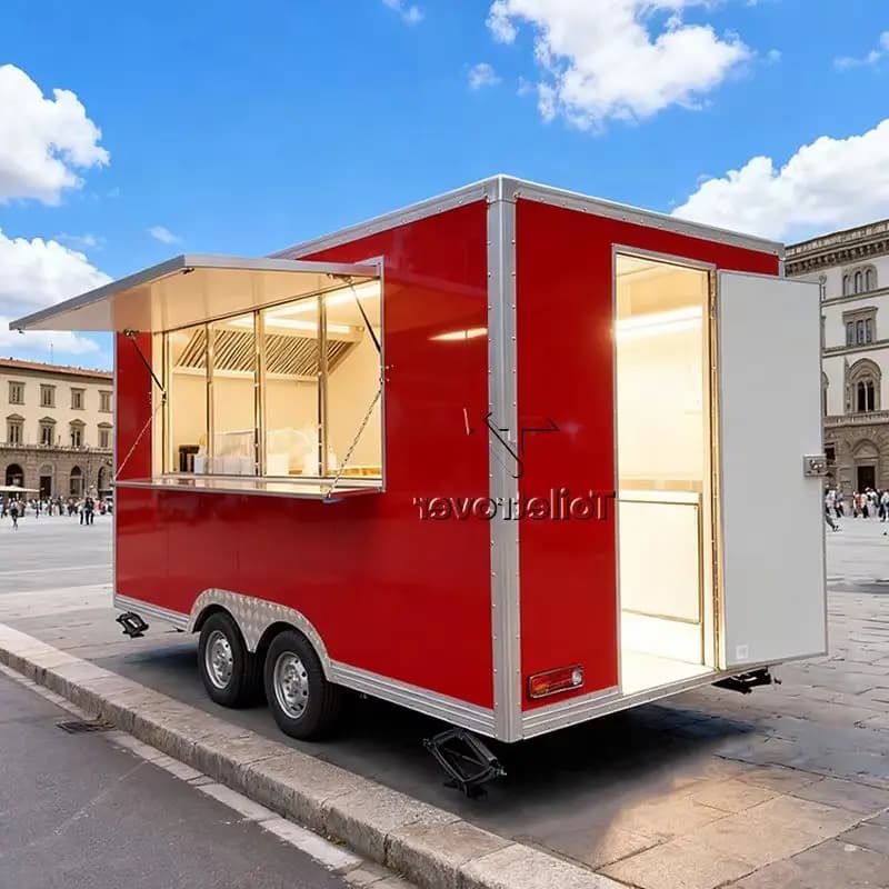 Red customizable vintage-style food trailer with an open service window on a city street.