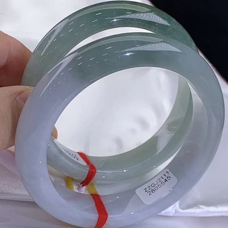Authentic Myanmar jadeite bracelet with a smooth, round finish and moist texture.