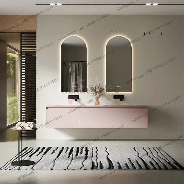 Modern pink floating bathroom vanity with a matte tempered glass integrated double basin and two arched lighted mirrors.