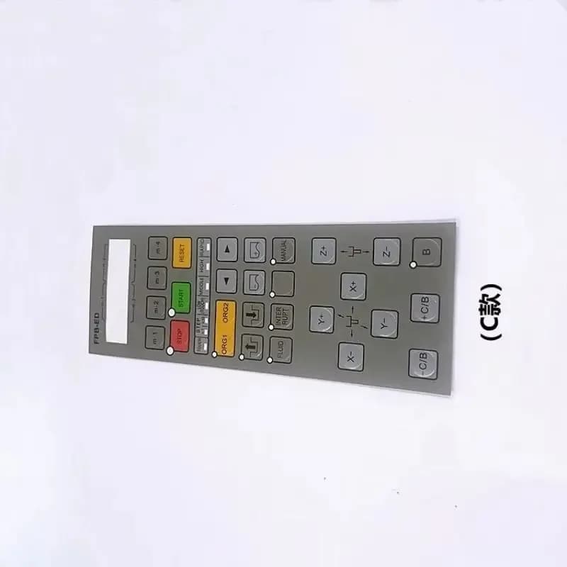 Gray operation panel keyboard overlay for Makino wire EDM machines with various control buttons.