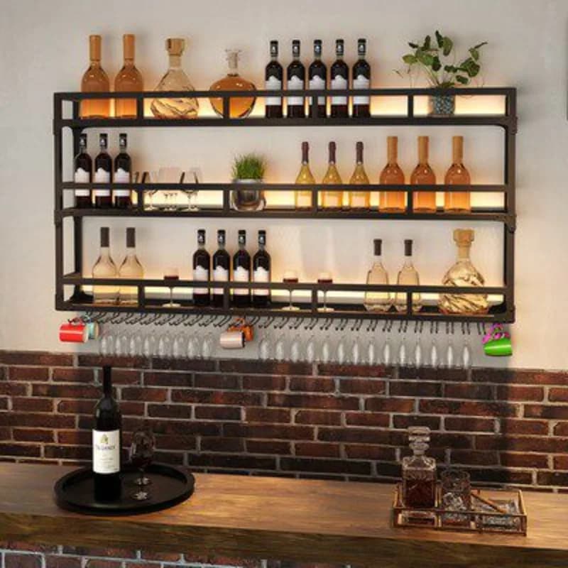 Wall-mounted black metal bar shelf with wine bottles and glassware storage.