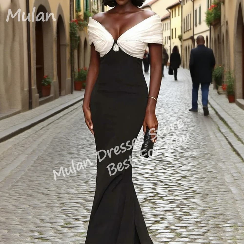 Elegant black mermaid evening dress with a contrasting white off-the-shoulder bodice.