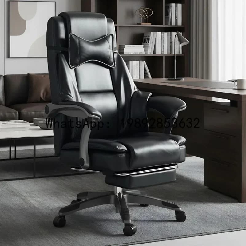 Modern black leather executive office chair with integrated headrest and footrest in a home office setting