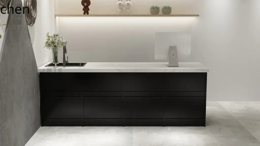 Modern black cashier counter with a white marble top in a boutique floral shop setting.