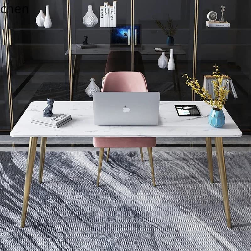 Modern Italian style office desk with a white marble-patterned rock slab top and gold-finished legs.