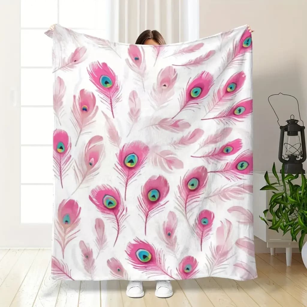 Soft white flannel throw blanket with vibrant pink peacock feather patterns