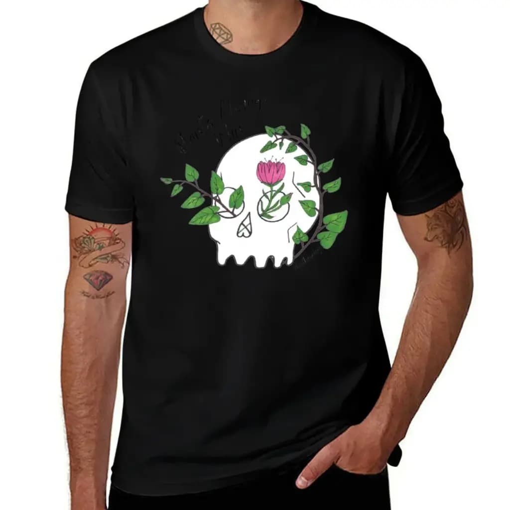 Men's black t-shirt featuring a white skull illustration with green vines and a pink flower growing through it.