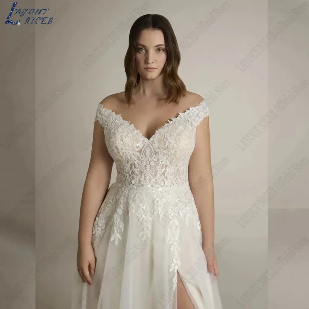 Bride wearing a white V-neck A-line wedding gown with cap sleeves and side slit.
