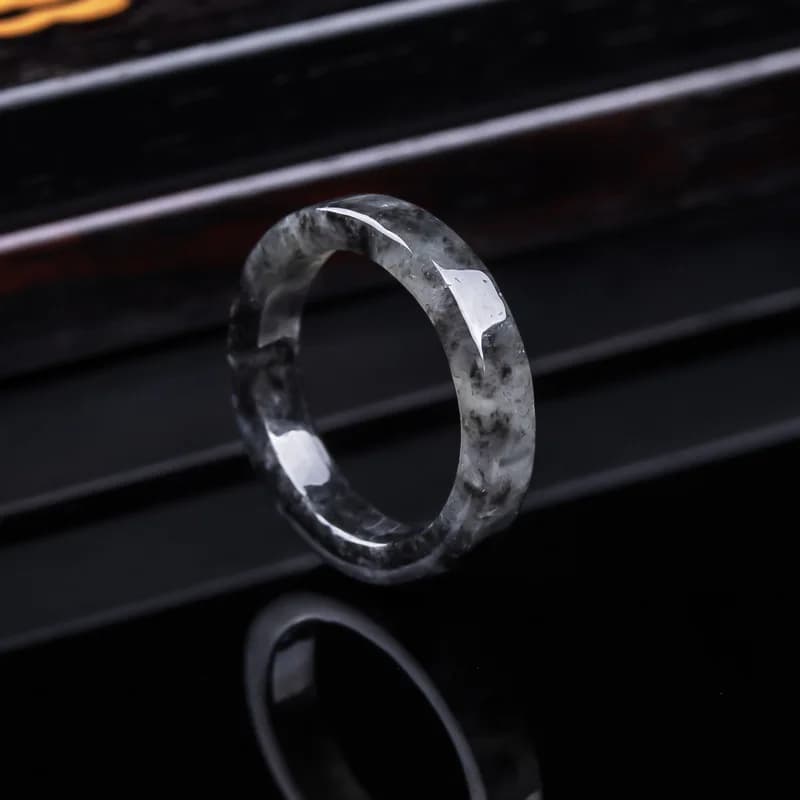 Genuine Burmese black jadeite ice-type ring with natural stone patterns.