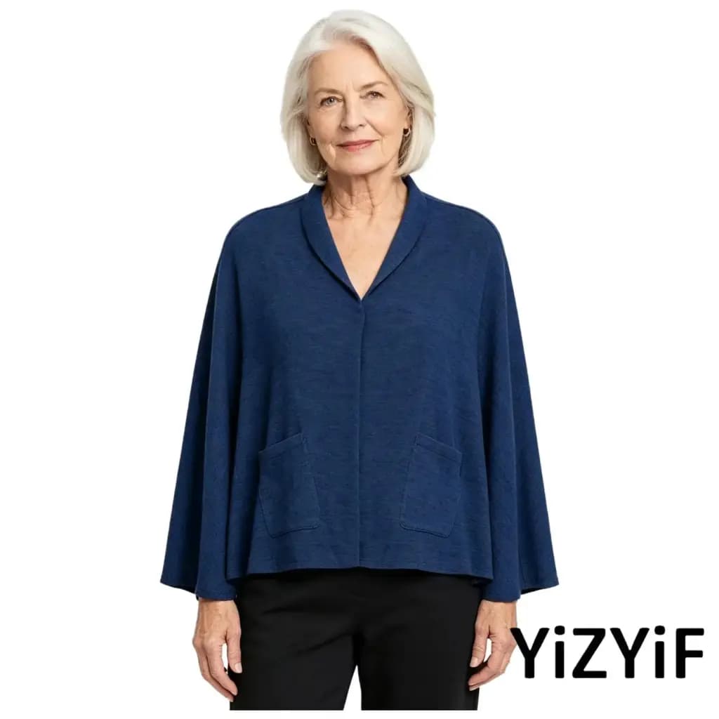 Elderly woman wearing a blue V-neck adaptive cape shawl with pockets.